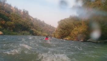 Adventuring Kayaker in floating down Cache Creek