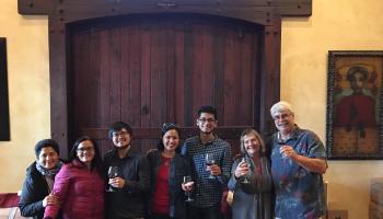 A group of people participating in a wine tasting tour.